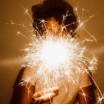 person holding white dandelion flower