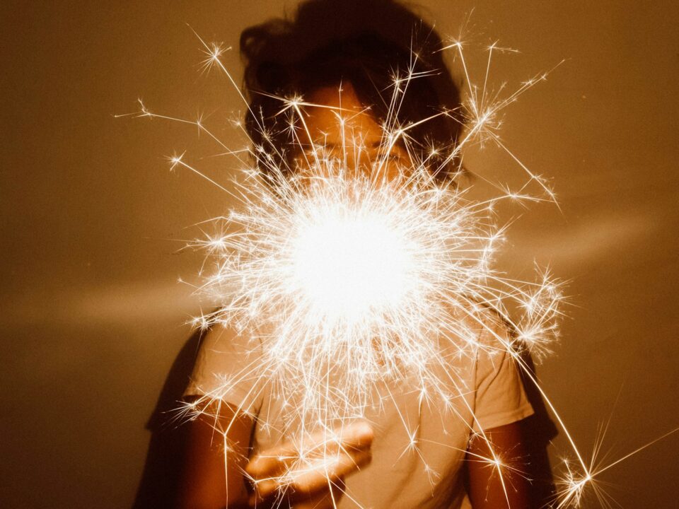 person holding white dandelion flower