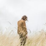 person standing in the middle of wheat field