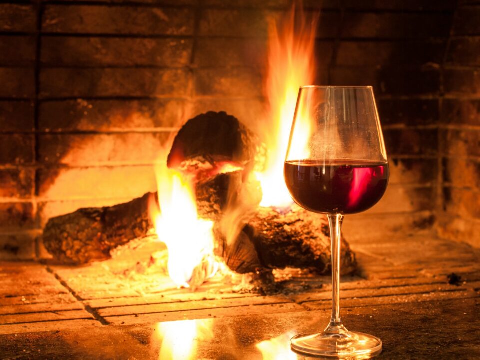 clear wine glass with red wine on brown wooden table
