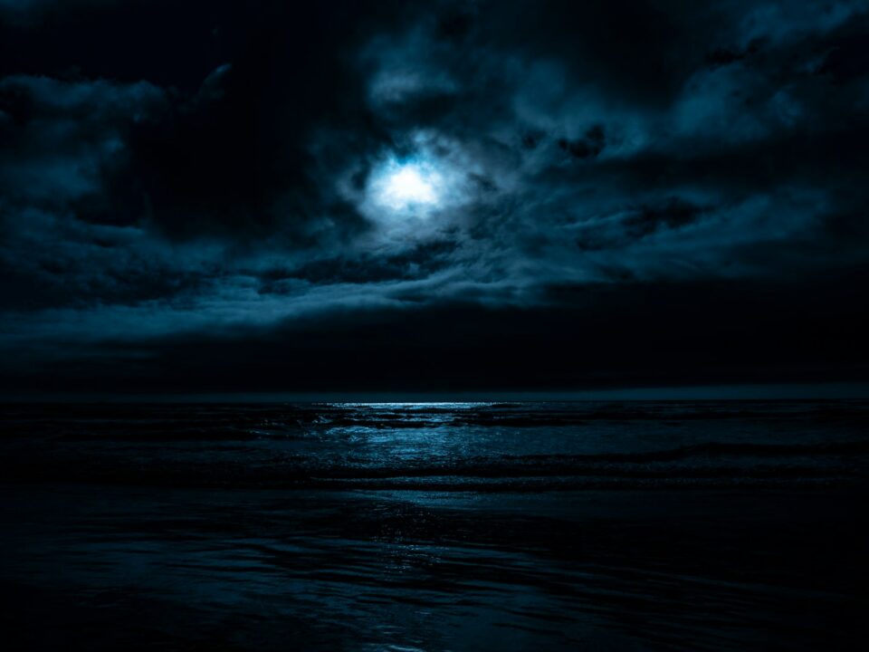 body of water under full moon