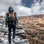 person standing on gray rock during daytime