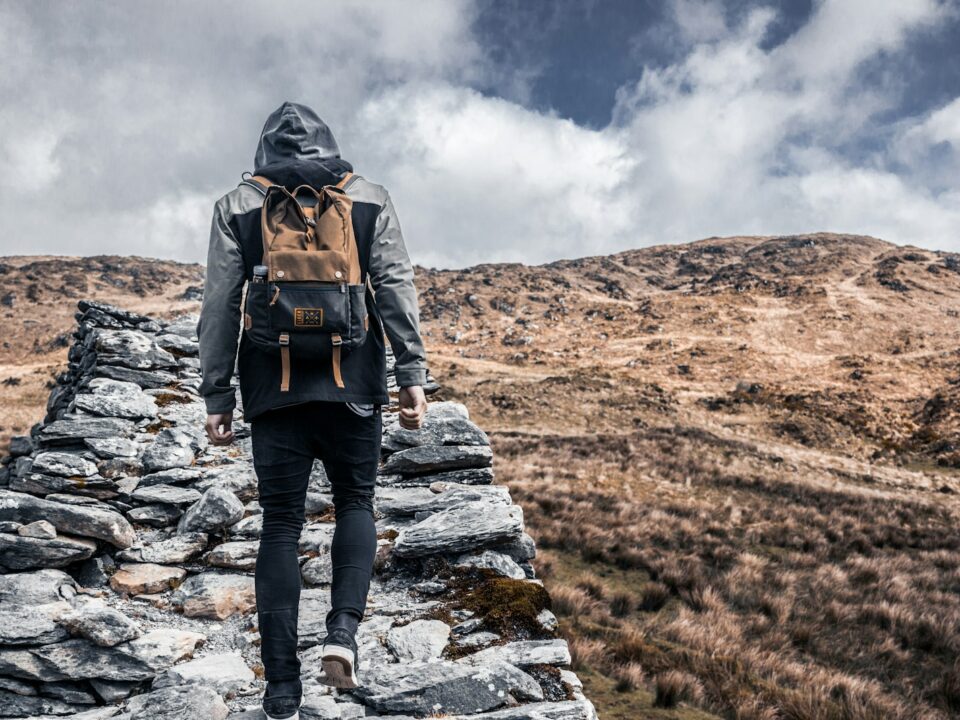 person standing on gray rock during daytime