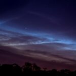 grey cloudy night sky over forest