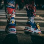 person in black white and orange nike shoes