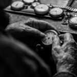 grayscale photo of person holding pocket watch