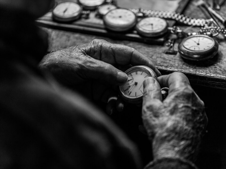 grayscale photo of person holding pocket watch