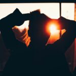 silhouette of woman holding hair