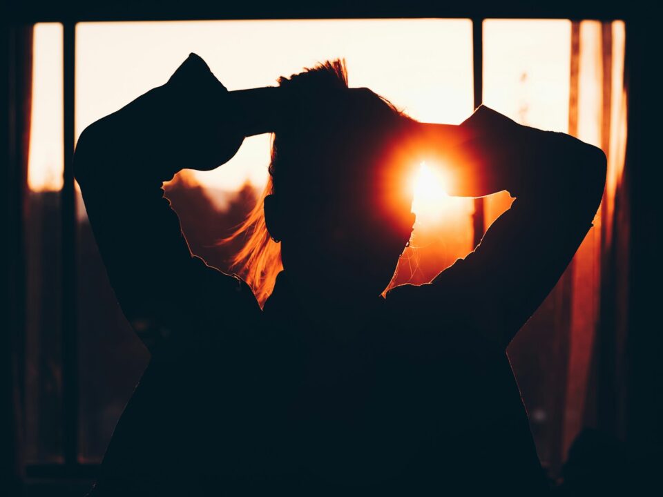 silhouette of woman holding hair