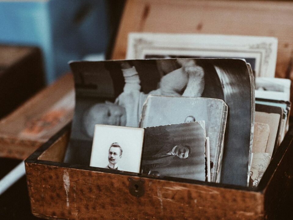 old photos in brown wooden chest