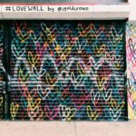 photo of black door shutter filled with heart murals
