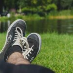 person wearing black and white sneakers