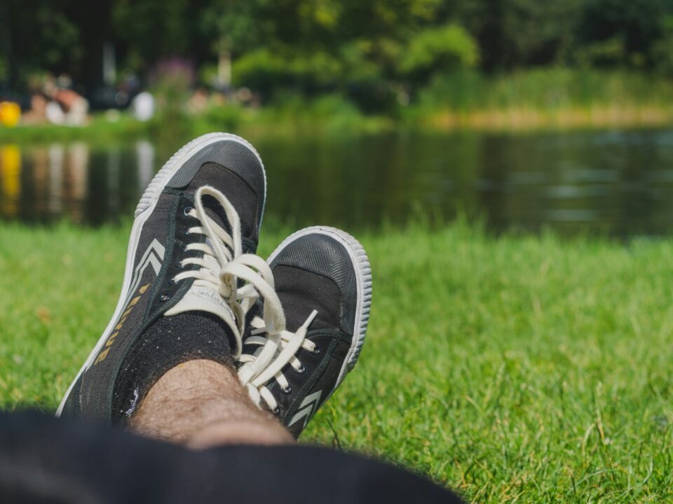 person wearing black and white sneakers