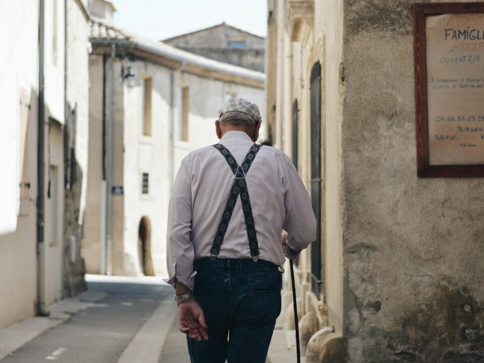 man standing beside white wall