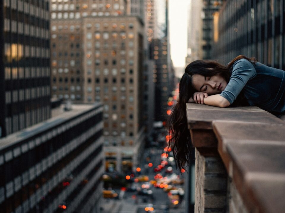 woman leaning on top building rail during daytime