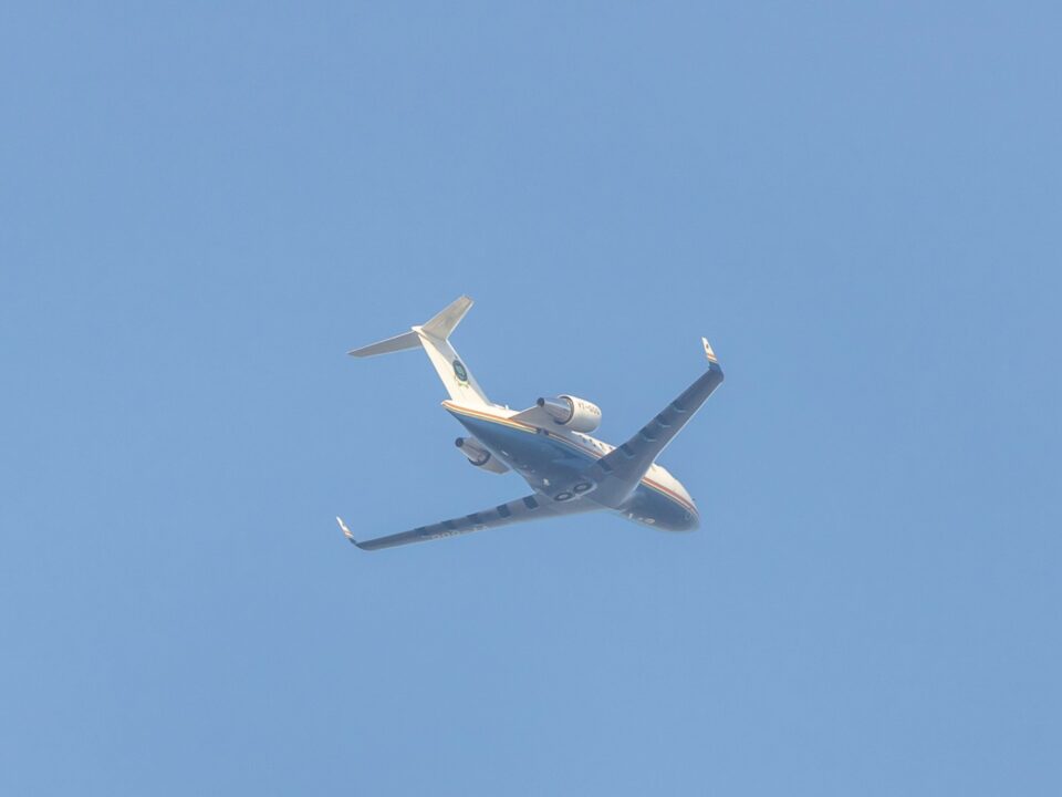 a large jetliner flying through a blue sky