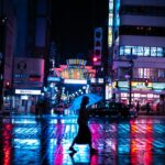 a woman walking down a street holding an umbrella