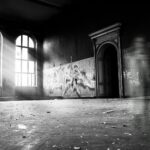 grayscale photo of person standing inside building