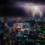 aerial view of city buildings with lightning strike