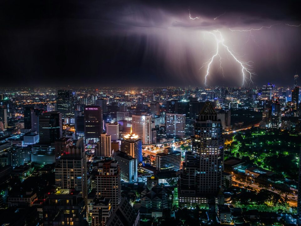 aerial view of city buildings with lightning strike