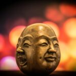 selective focus photography of buddha bust decor