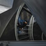 man walking on spiral stairs