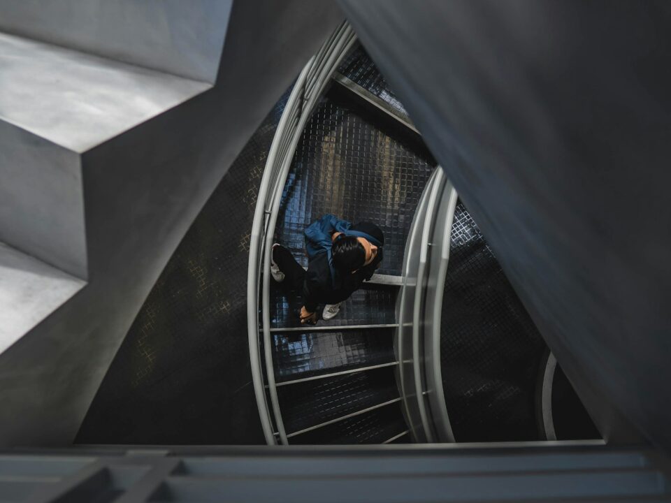 man walking on spiral stairs