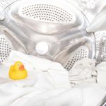 a rubber ducky toy sitting inside of a washing machine