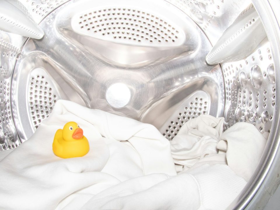a rubber ducky toy sitting inside of a washing machine
