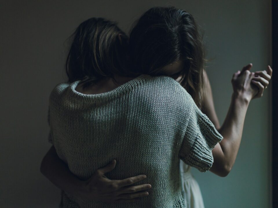 two women hugging each other