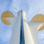 a tall white building with a mickey mouse head on it's side
