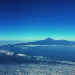 mountain with clouds under blue sky