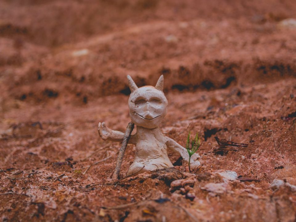 white figure beside green plant