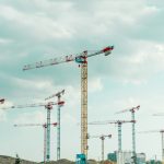 a group of cranes sitting on top of a field