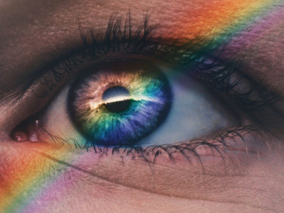 close up photography of rainbow rays on eye