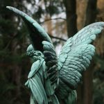 a statue of an angel holding a bird