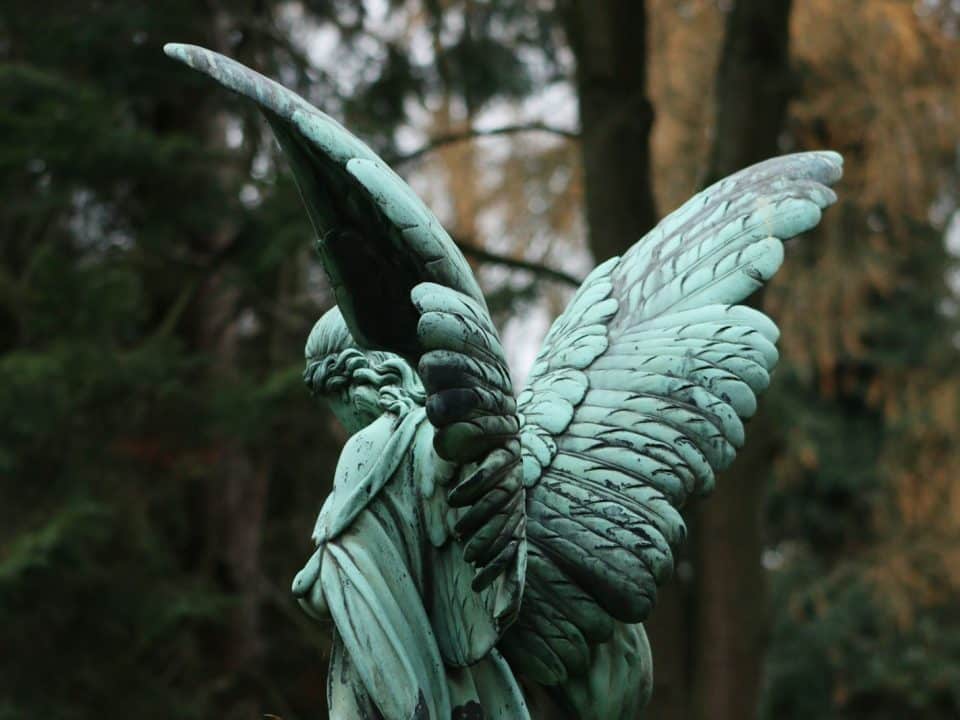 a statue of an angel holding a bird