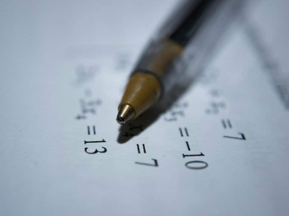 black retractable pen on white printer paper